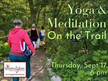 People walking on a forest trail promoting yoga and meditation event.