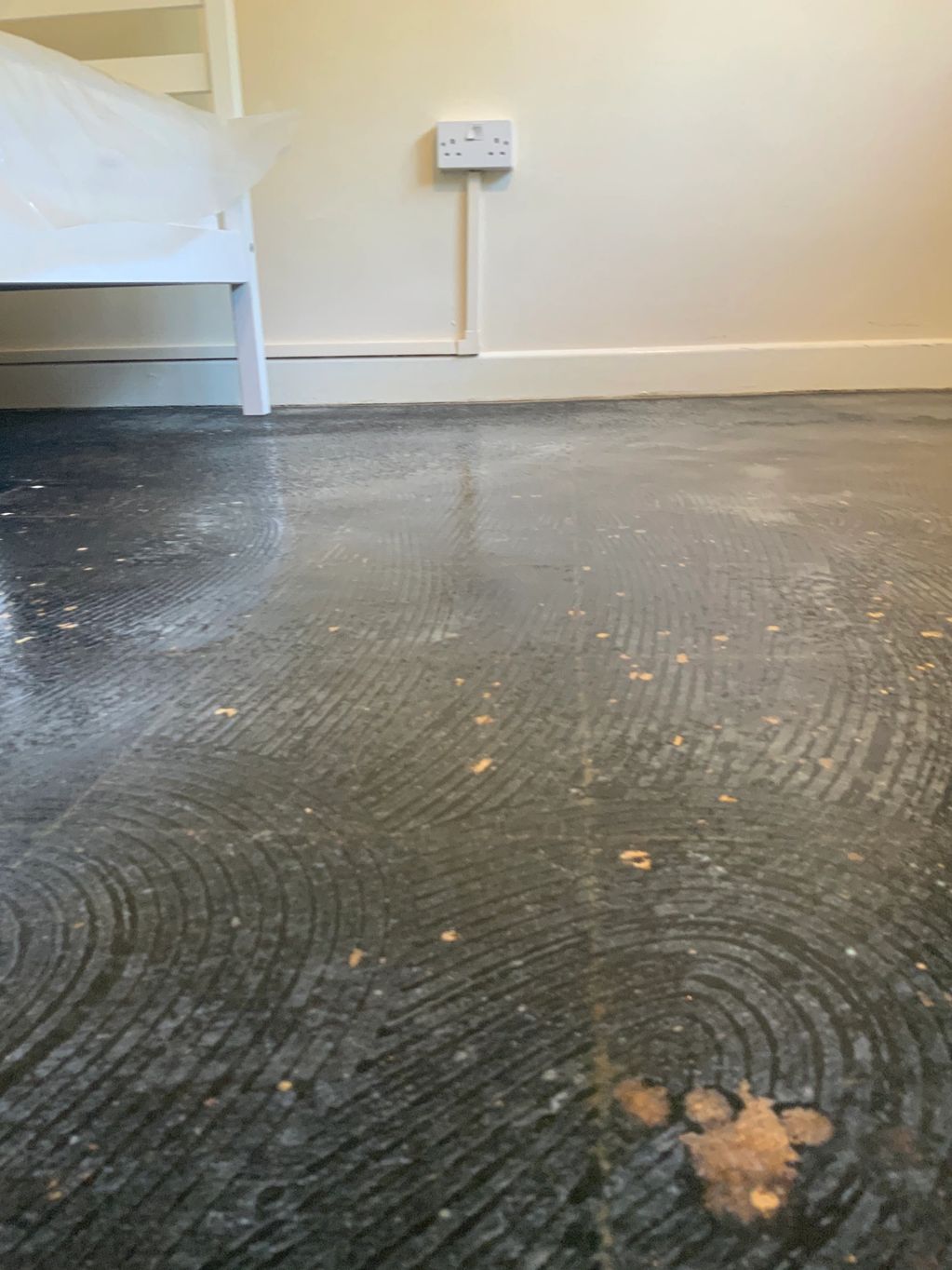Picture detailing the floor being sealed with PVA glue following the removal of asbestos floor tiles