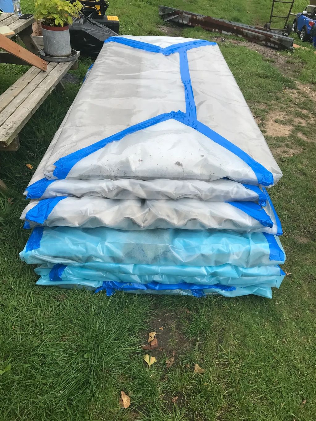 Asbestos cement roof sheets wrapped in 1000 gauge polythene.