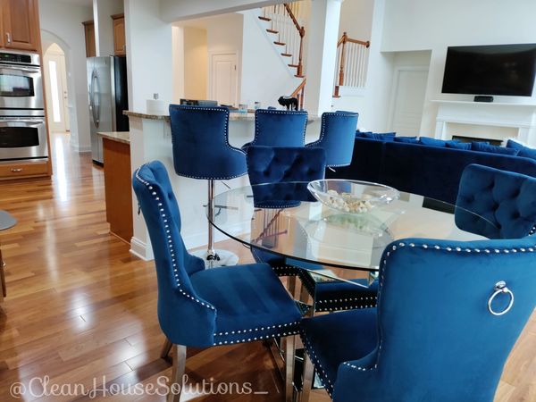  Residential cleaning. Glass dining room table. Home or house cleaning. Blue velvet dining chairs