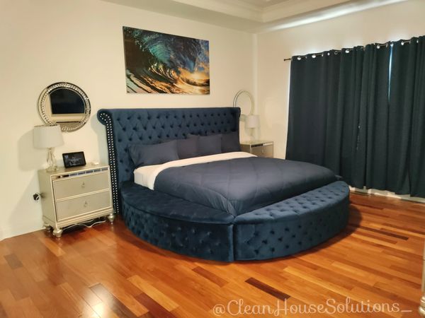Beautiful bed making. Bedroom cleaning & organizing. Designer bedding. Blue blanket. Hardwood floor