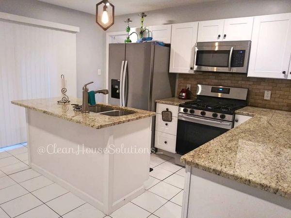 Kitchen Cleaning. Beautiful kitchen. granite countertops.  Stainless steel appliances. Sink stove