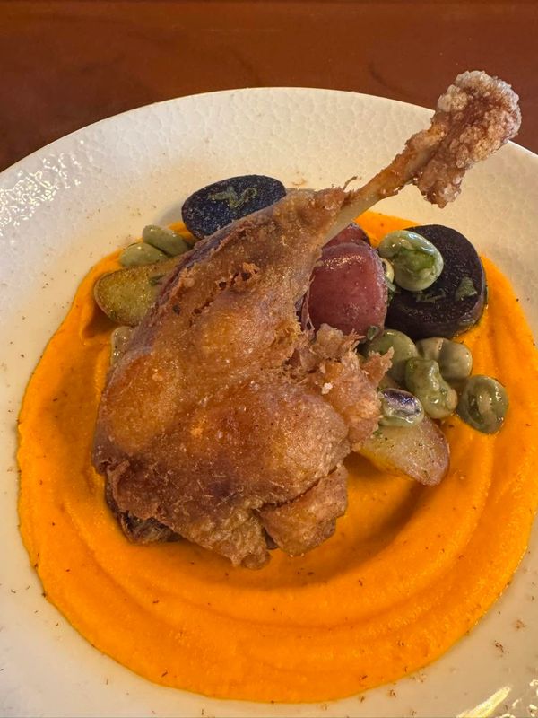 crispy duck leg dish with potatoes