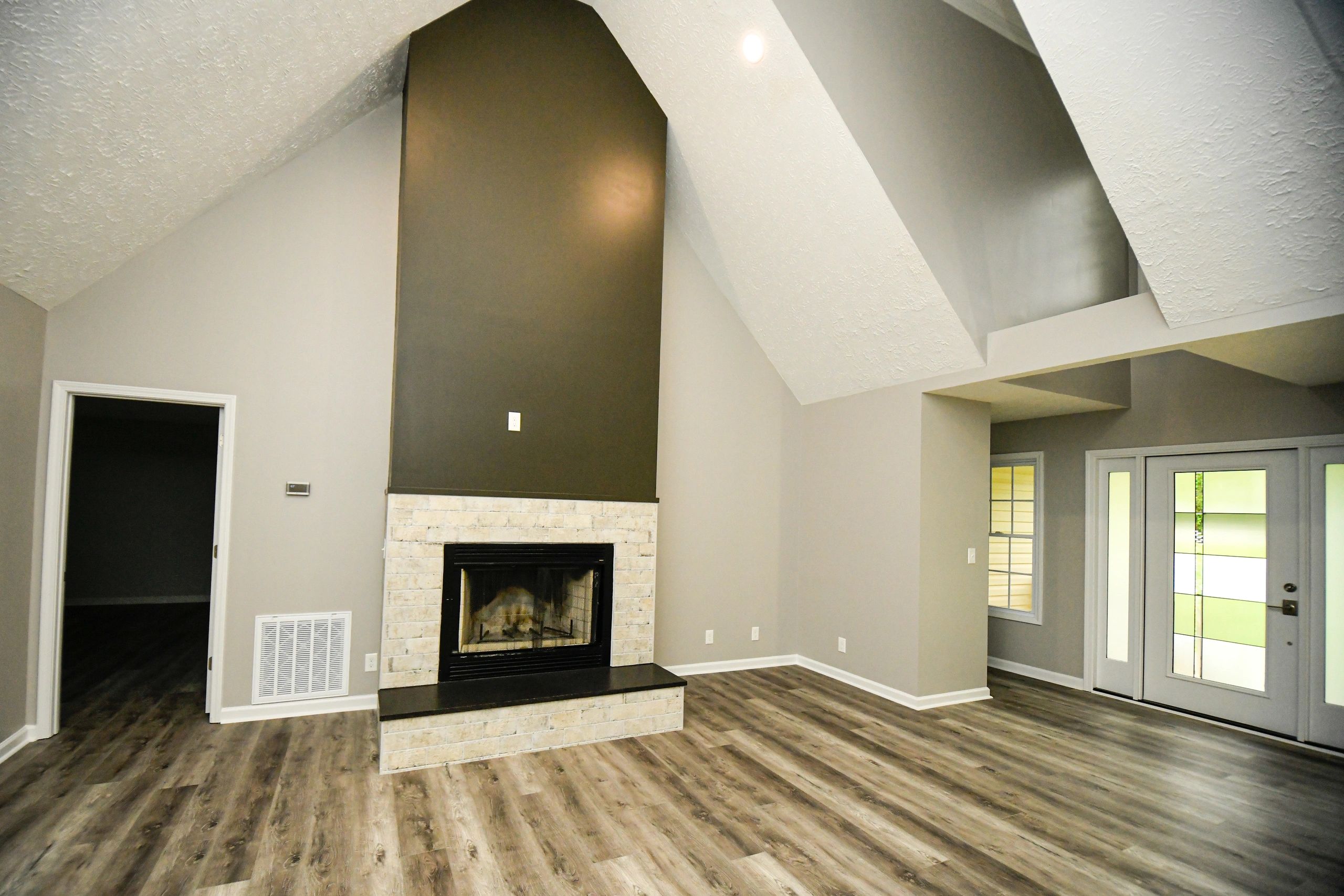 Beautiful Living Room with high ceilings and brick fireplace