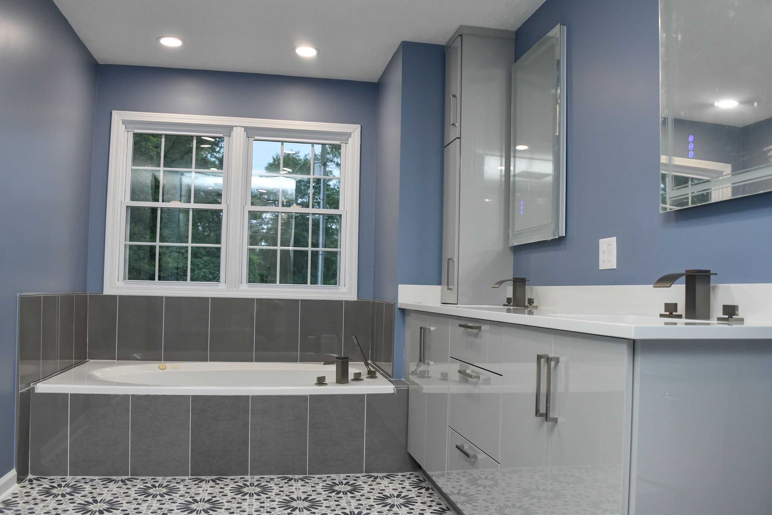 Modern primary bath with beautiful tiling and walk in shower.