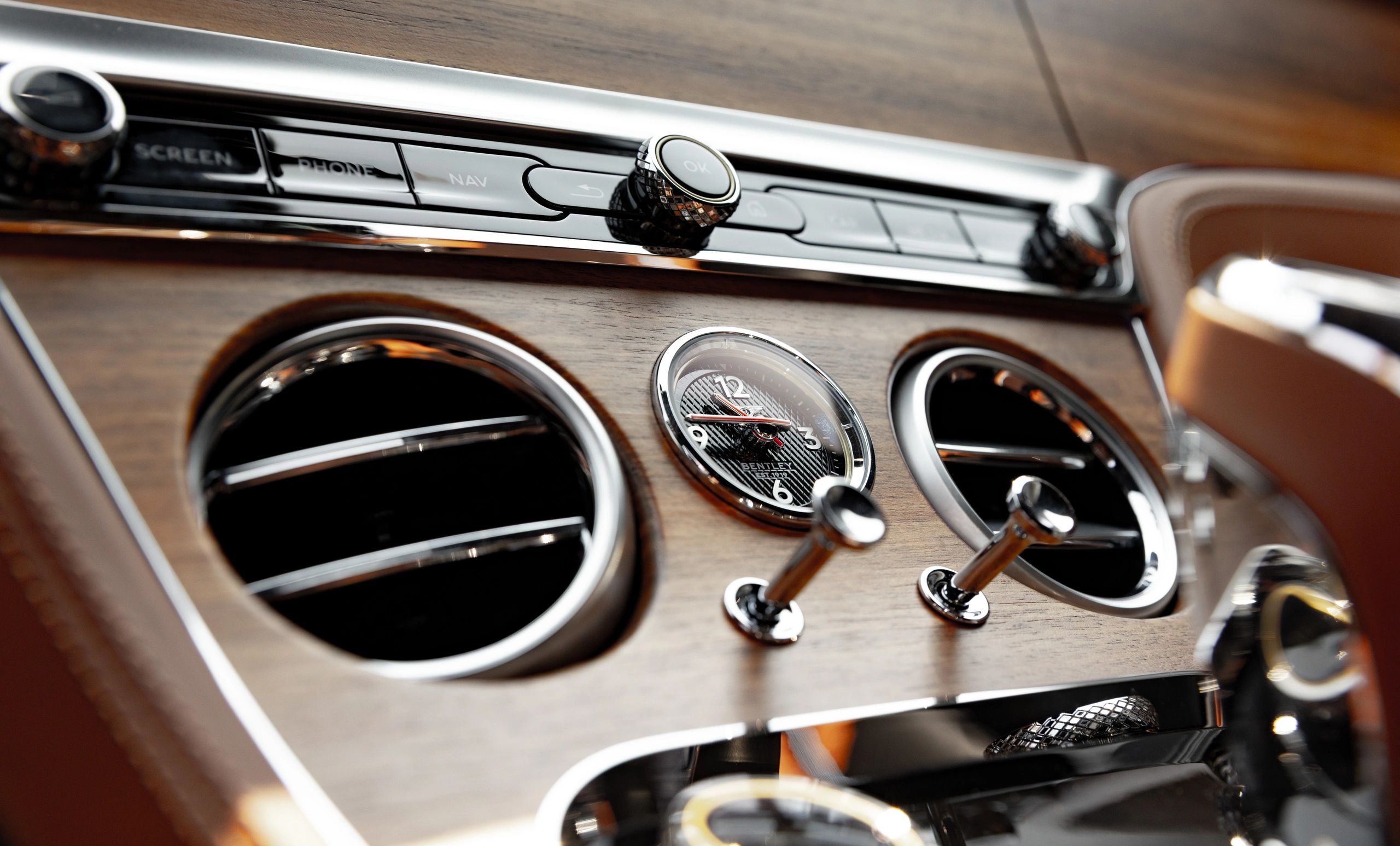 Bentley car dashboard with classic clock and controls.