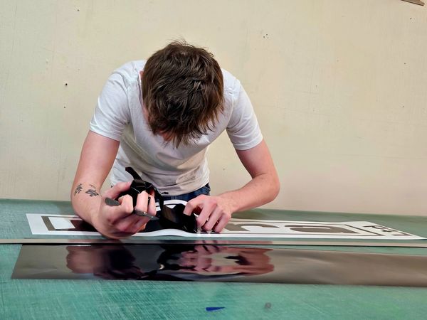 Young man cutting graphics