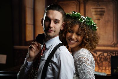 A bride and groom posing for a wedding portrait.