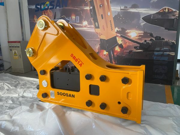 Soosan SIDE SB81A hydraulic breaker sits on protective wrapping in a facility.