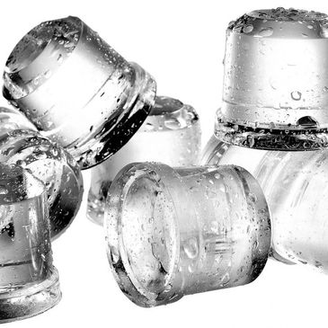 Close-up of wet, transparent ice cubes with water droplets.