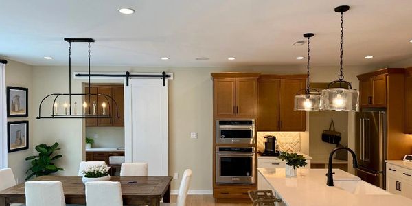 Dining room  showing profesionally installed recessed lighting, chandelier and pendant lights.