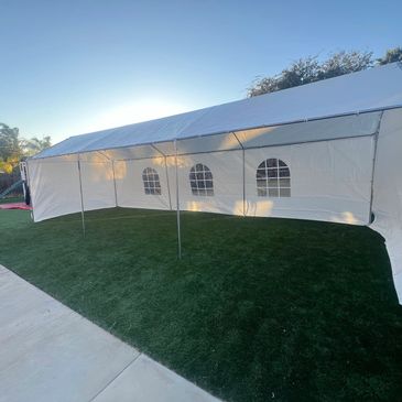 Large white outdoor tent on green grass.