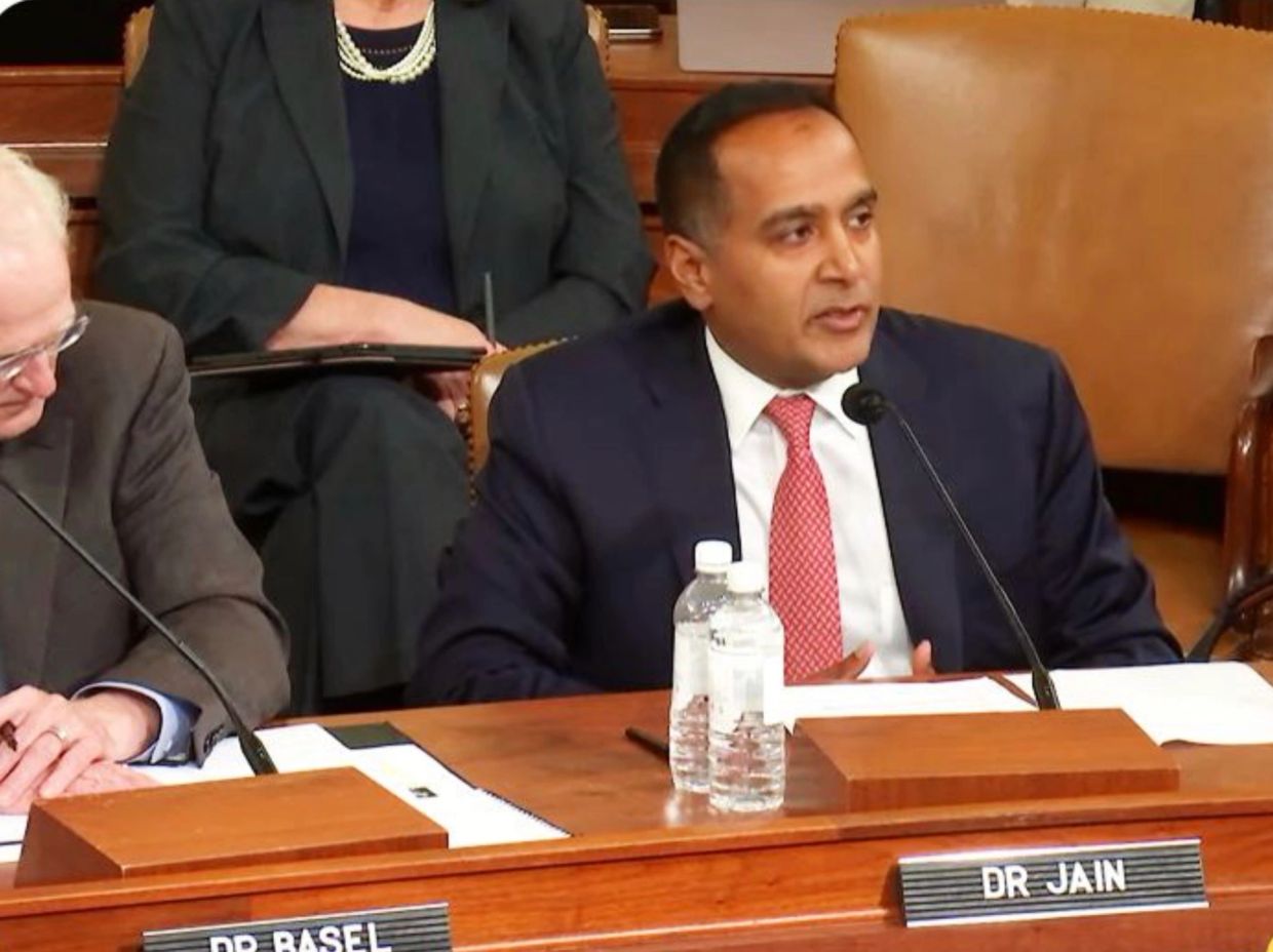 Man speaking at a formal meeting.