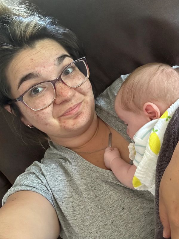 A picture of the baby sleeping on the mother 