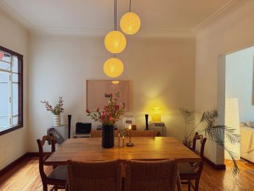 Cozy dining room with warm lighting and wooden furniture.