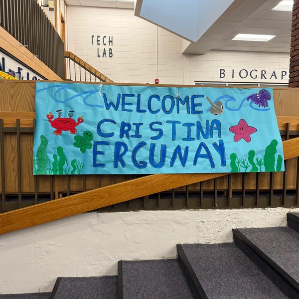 A colorful welcome banner for Cristina Ergunay with ocean-themed decorations.
