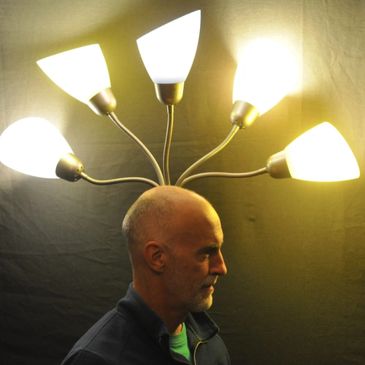 Illusion photo of five lamps emanating from Greg's head, showing how Greg has many repair ideas.