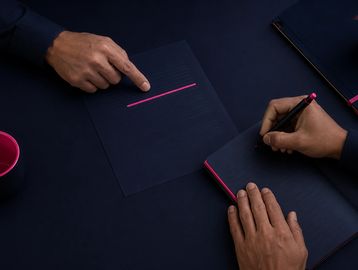 Mortgage broker taking personalised notes for a client during a home loan consultation at Coach Brok