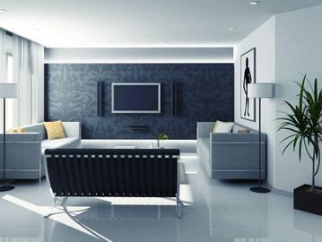 Modern living room with sleek furniture and dark accent wall.