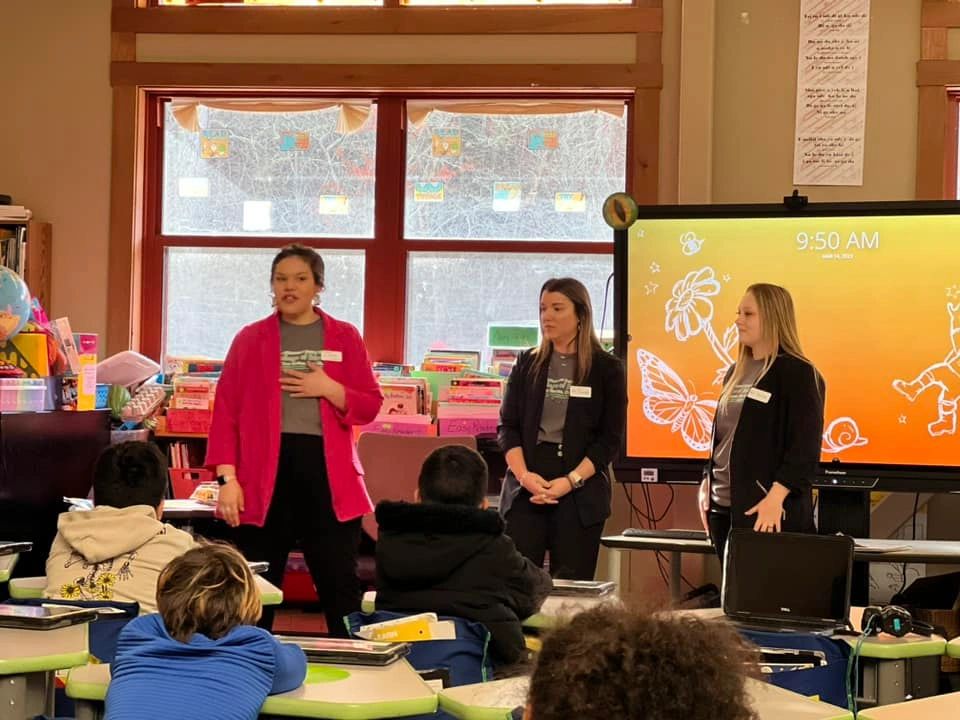 A group of young native women teaching Cherokee.