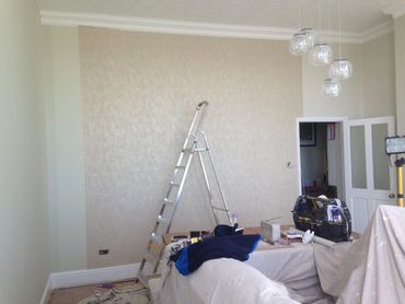 Wallpapering of a high ceiling living room in Kirkley, Lowestoft.