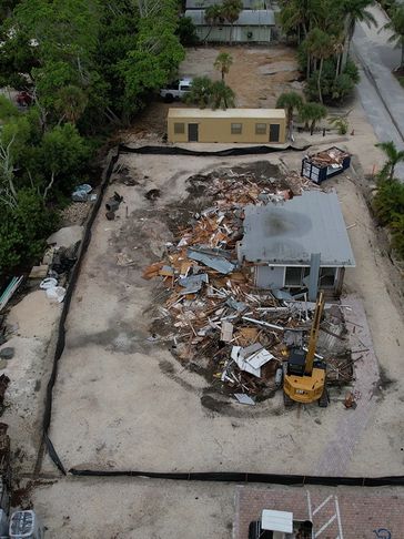 Site with debris and construction equipment.