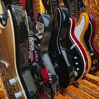 Guitars by Squire, Jackson, Fender, BMG, Aria, and Gibson