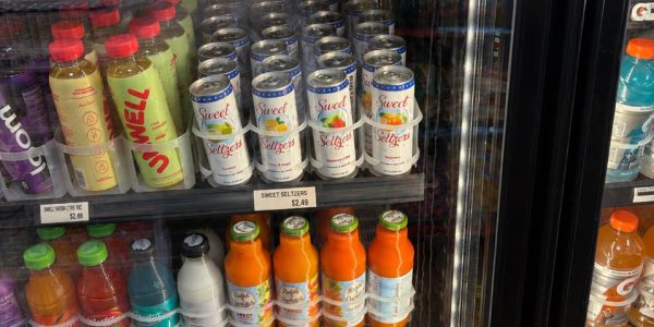 Beverage shelf in a refrigerated store display.