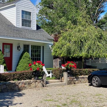 A house with a parked car in an open area