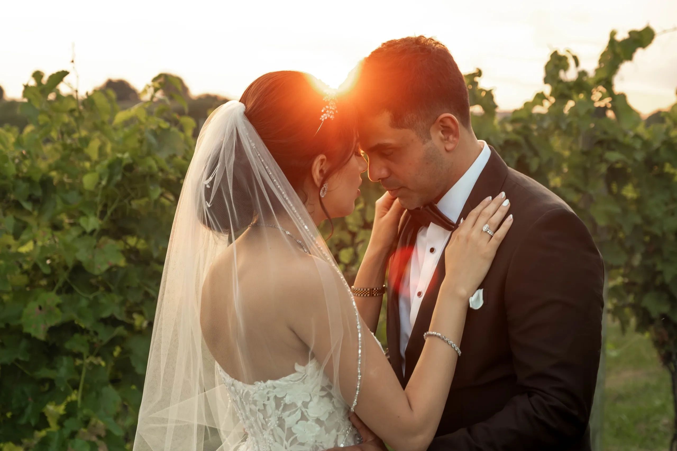 Bride and groom in an intimate moment at sunset.