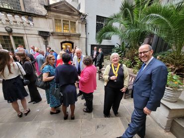People mingling in an outdoor courtyard.