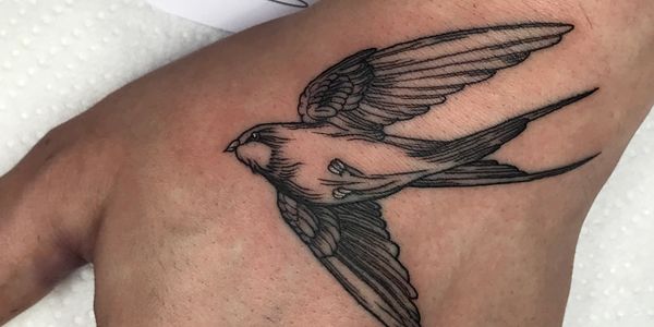 Fine line swallow bird tattoo on the hand