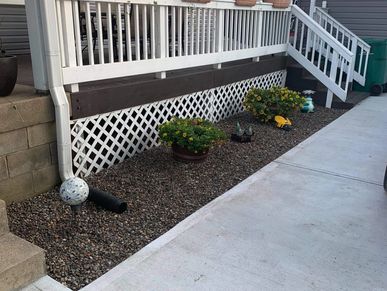 A Small River Rock Install to Revamp This Flower Bed