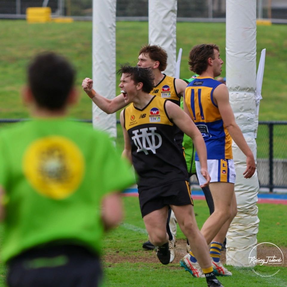 Football player celebrating a goal passionately.