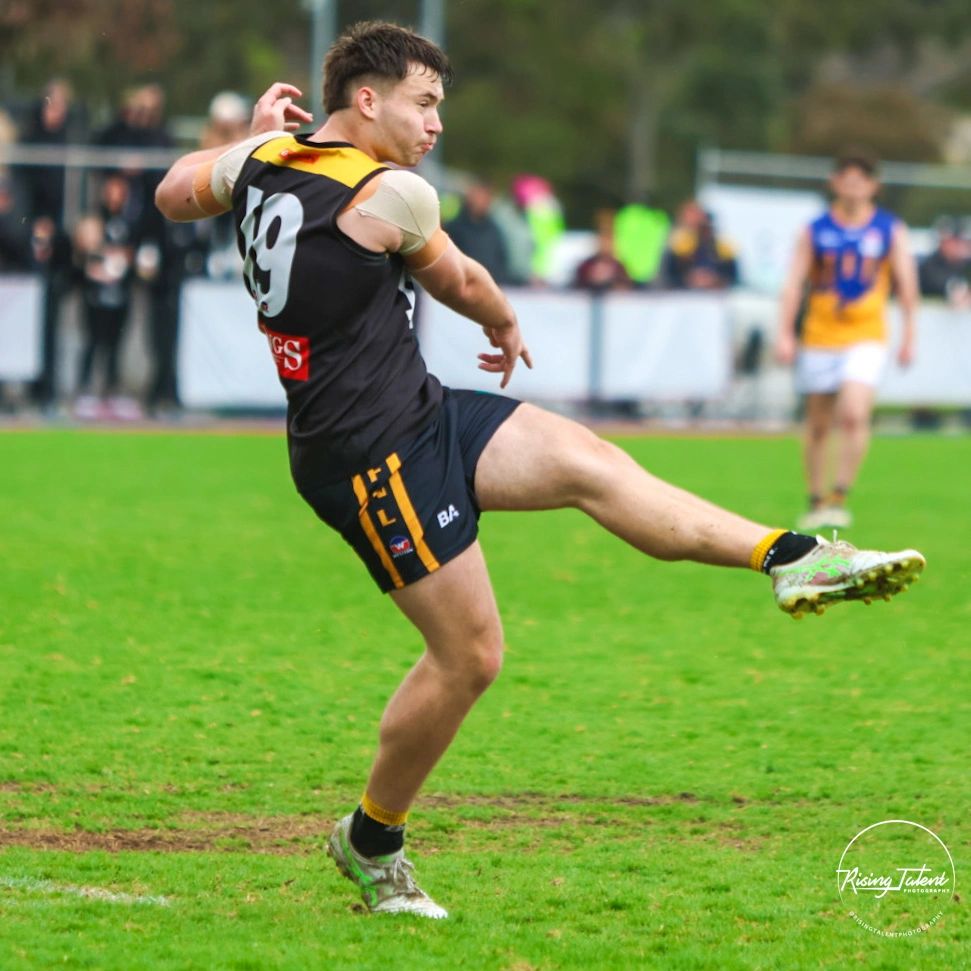 Football player kicks the ball during a game.