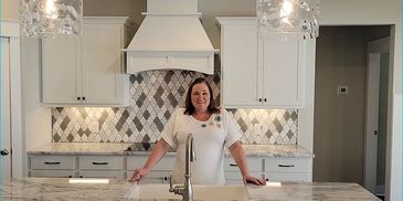 Angela Link, realtor, showing a kitchen in a new construction house in Murfreesboro, TN.