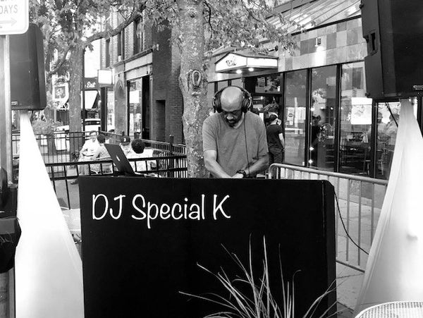 DJ Special K performing outdoors.