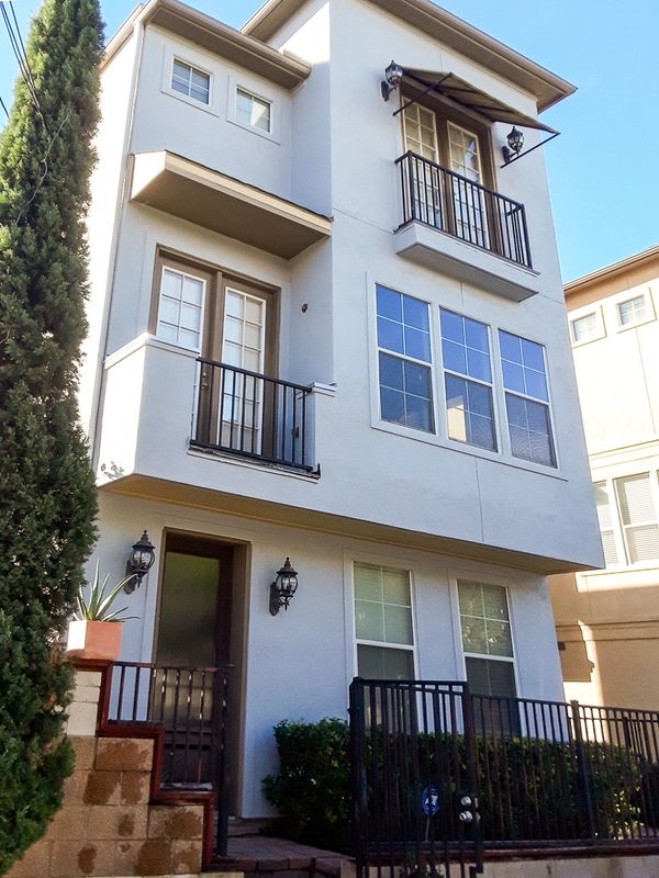 Townhome after stucco facade remodel. Stucco is nice and smooth. Ledge lines removed. Left view.