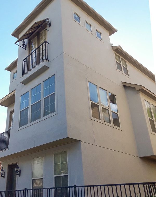 Townhome after stucco facade remodel. Stucco is nice and smooth. Ledge lines removed. Right view.