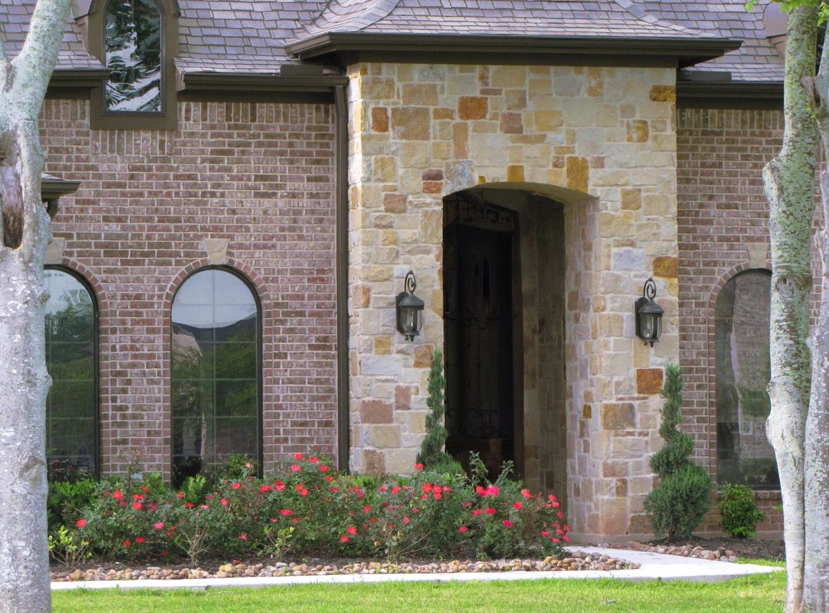 A stone with brick at the front elevation and stone at the Main Porch.
