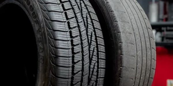 Side-by-side comparison of a new tire and a worn-out tire.