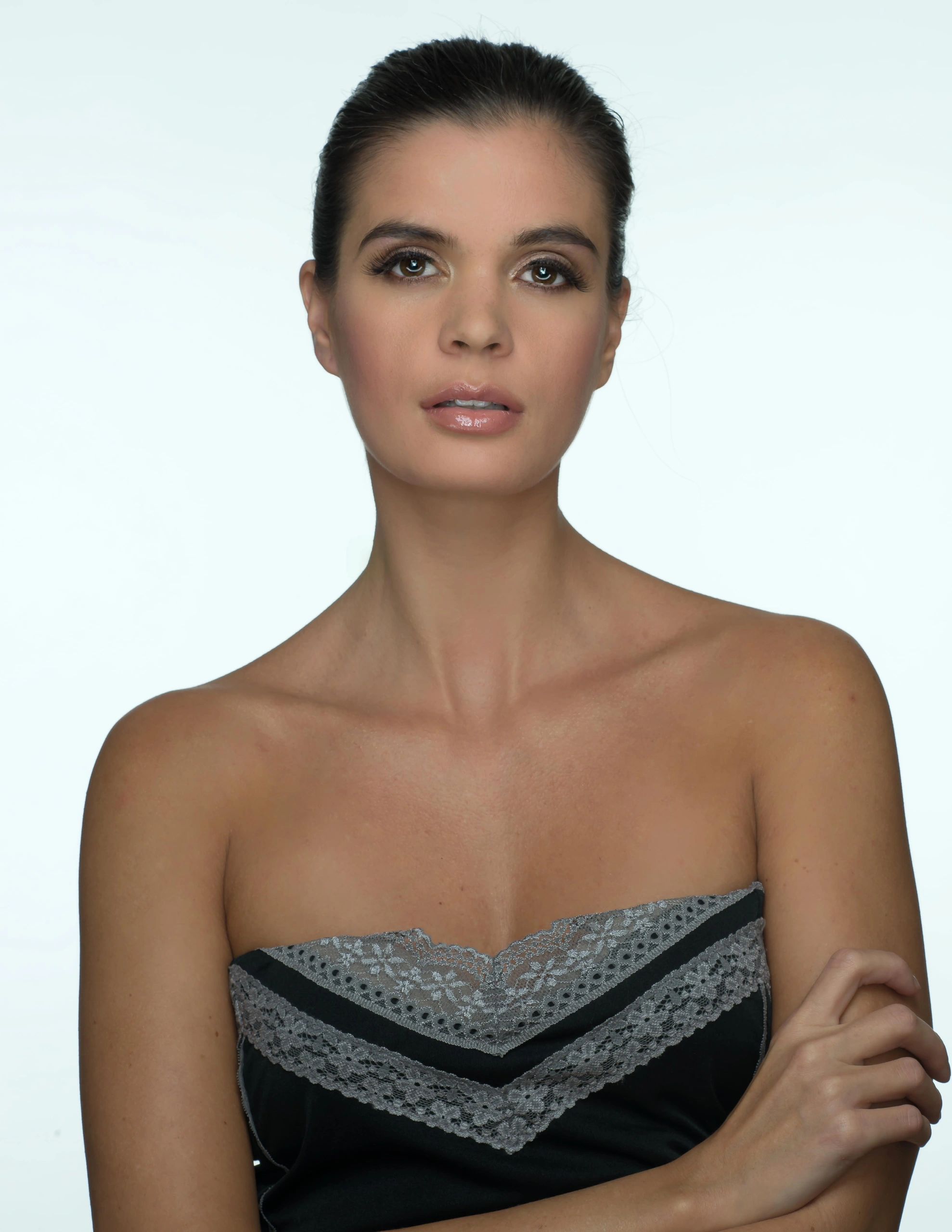 Close-up portrait of a woman with sleek hair and natural makeup.