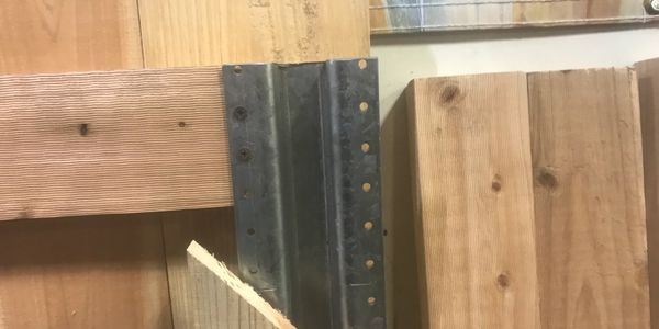 Close-up of wooden planks and a metal bracket.