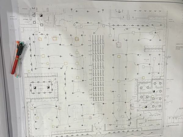 Technical blueprint with connected nodes and annotations, accompanied by colored markers.