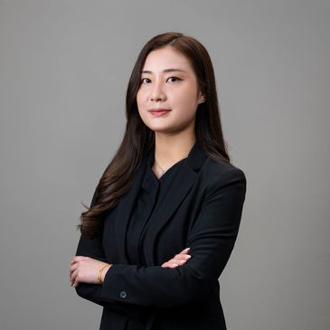 Confident professional woman in black suit.