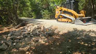 Spreading gravel over a driveway in Norman, Oklahoma.