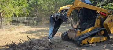 pulling stumps from the ground after mulching services in Norman, Oklahoma. 
