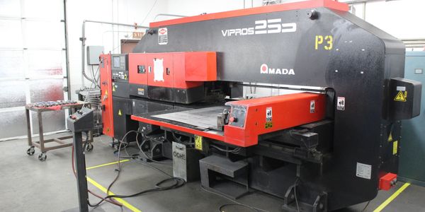 Industrial Amada VIPROS 255 metalworking machine in a workshop.