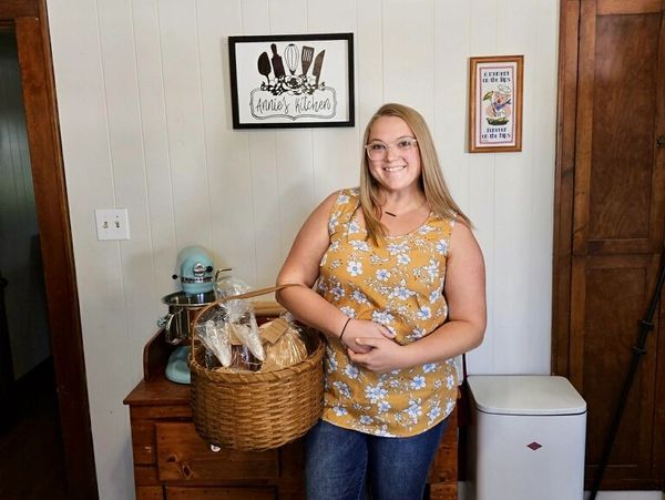 baker with baked goods in basket 