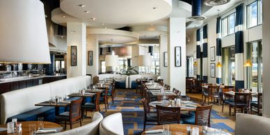 Spacious, modern restaurant with elegant seating and large windows.